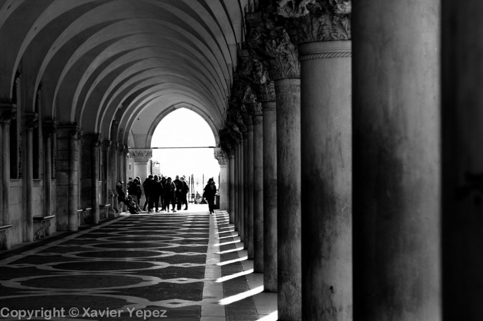 Black and white photo of the arcs on the right side of the Piazza San Marco in Venice, Italy