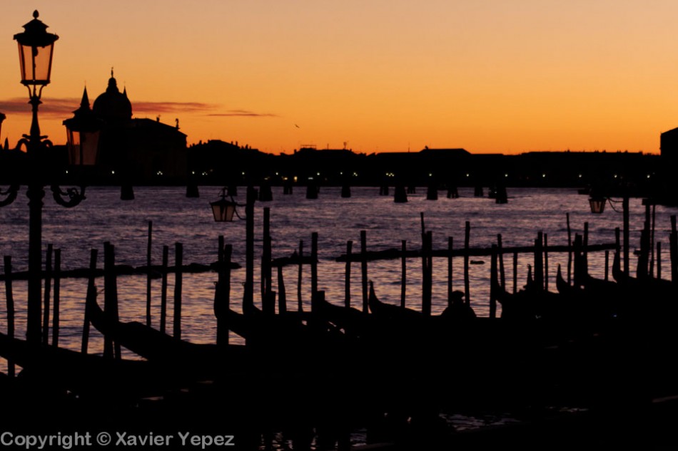 Silhouettes of gondolas against a sunset, Venice, Italy